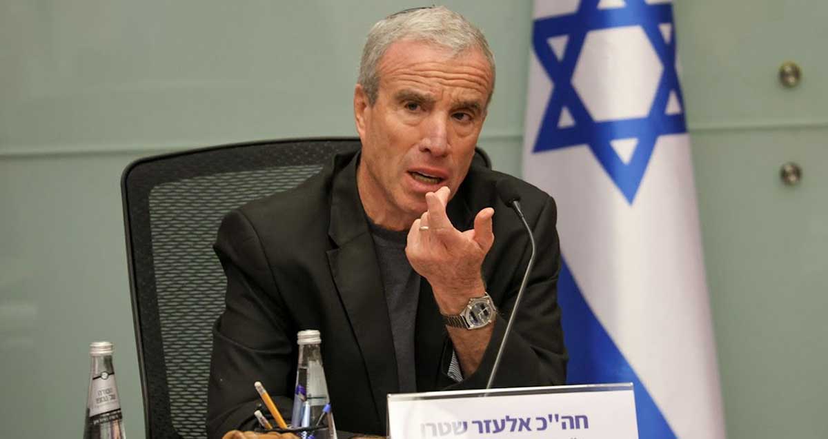 ח"כ אלעזר שטרן, יו"ר וועדת משנה משא"ן בצה"ל יושב באולם הוועדה עם מיקרופון לפניו ומאחוריו דגל המדינה.